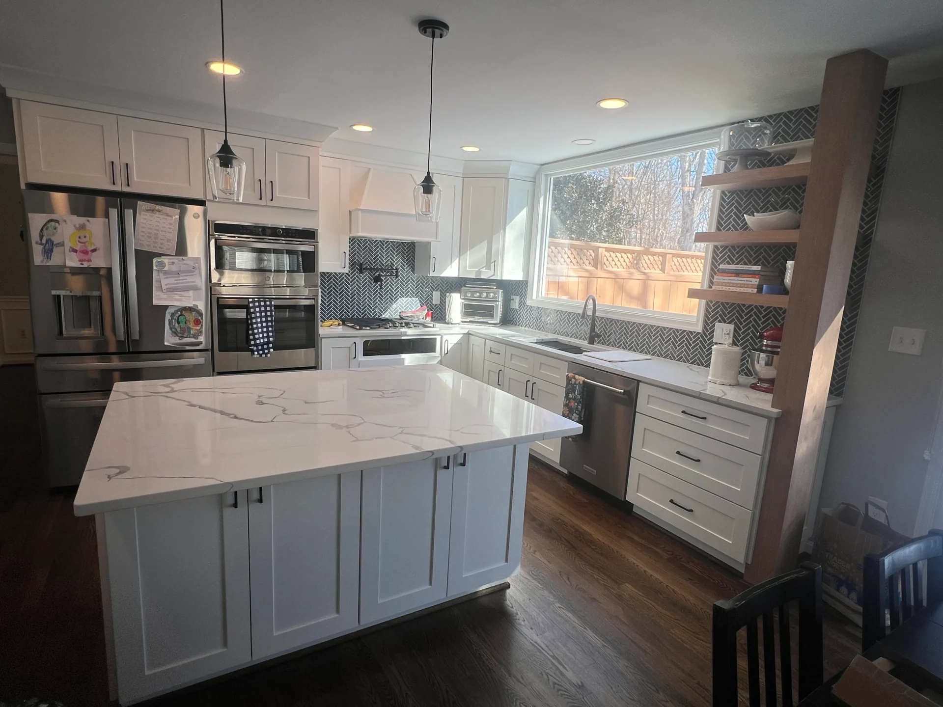 Kitchen Design Center remodel in Fairfax, VA with pendant lighting over a stone island